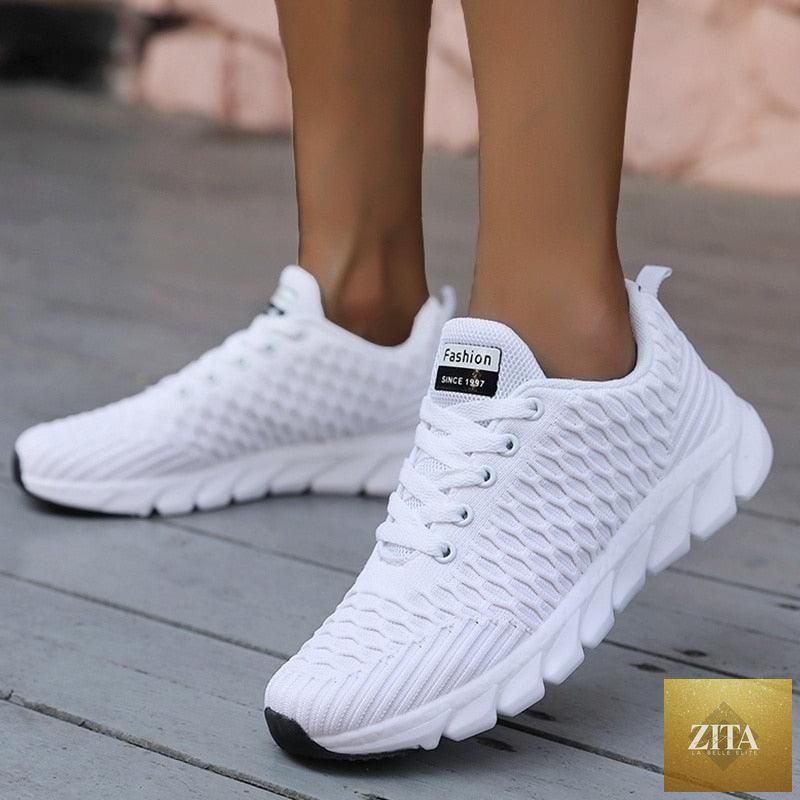 Women Stevvex running sneakers with breathable mesh, lightweight flat shoes, lace-up design, perfect for outdoor casual and sports use.