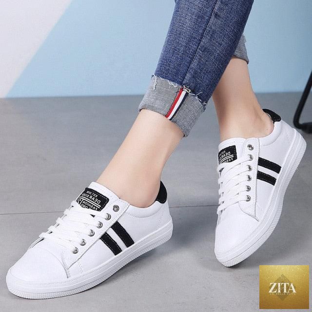 Women’s genuine leather sneakers by Stevvex, casual white vulcanized sports shoes with flat sole and stylish tennis-inspired design.