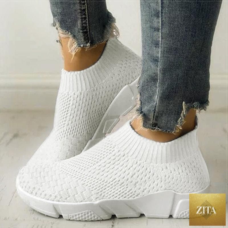 Women slip-on white sneakers by Stevvex with breathable mesh, lightweight vulcanize design, perfect for casual walking and workouts.