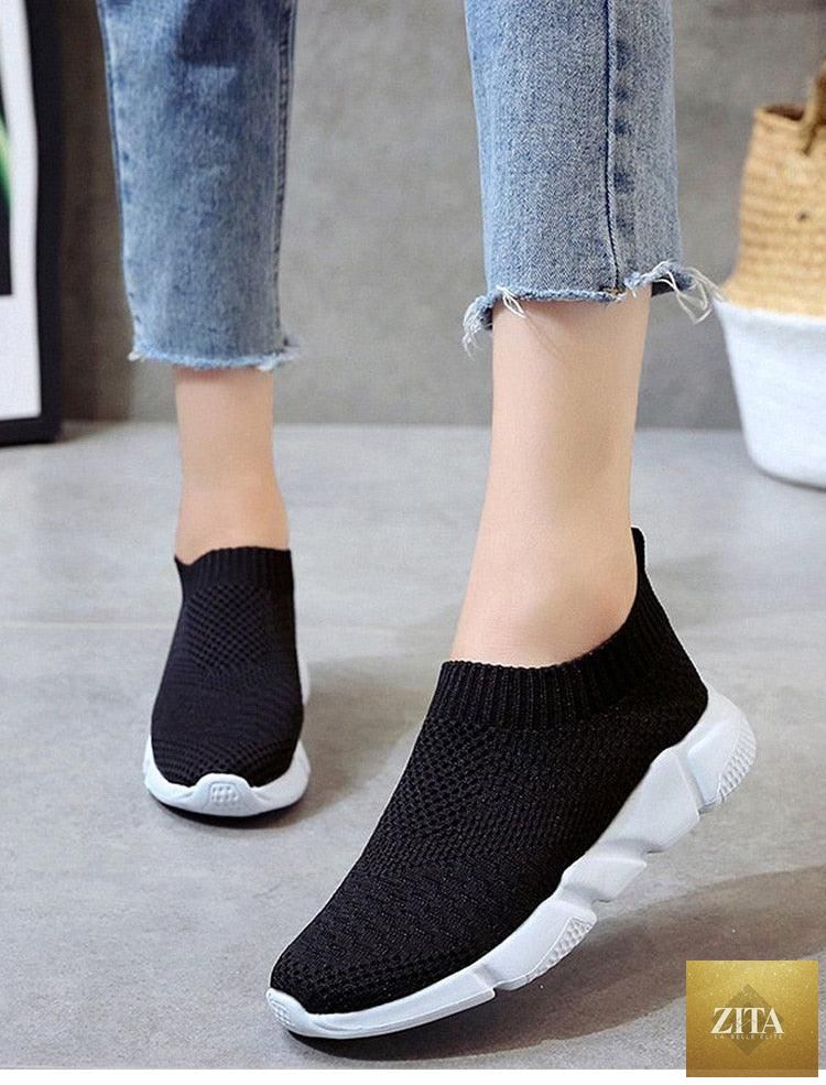 Women Stevvex slip-on white sneakers with breathable mesh, lightweight vulcanize sole, ideal for casual walking and light sports.