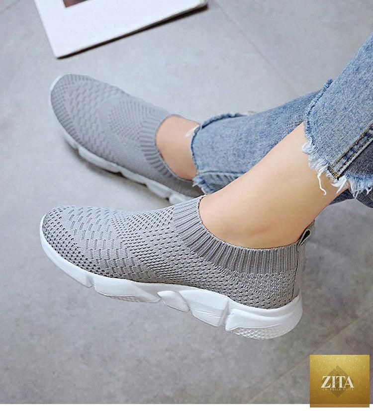 Women Stevvex slip-on white sneakers with breathable mesh, lightweight vulcanized design, casual and walking shoe style.