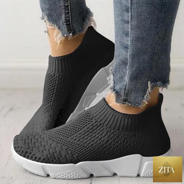 Women Stevvex slip-on white sneakers with breathable mesh, lightweight vulcanize design, ideal for casual walking and workouts.