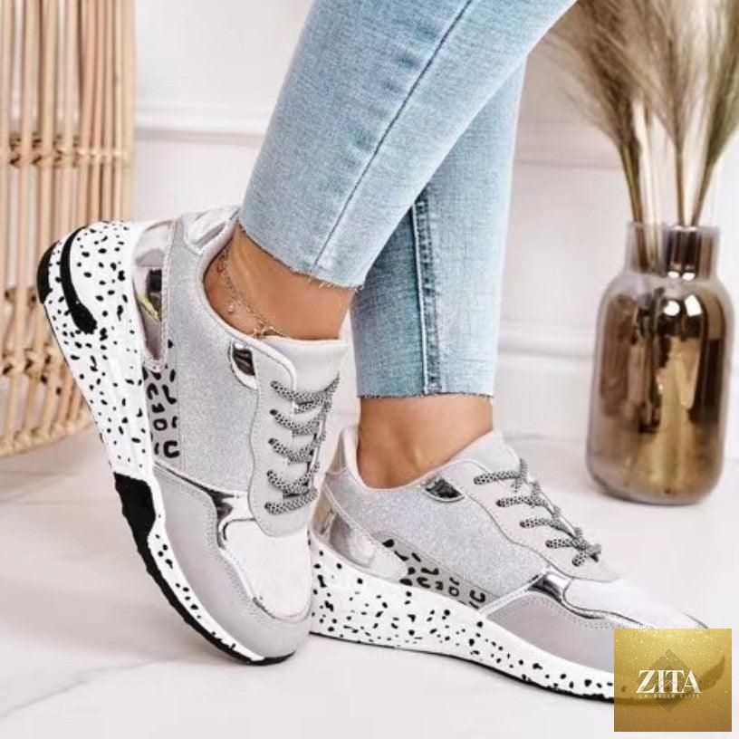 Stevvex women's leopard print sports sneakers with lace-up design, breathable material, and height-increasing sole for running and walking.