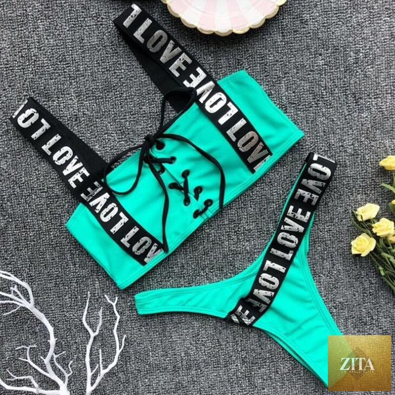 Women wearing a Stevvex two-piece push-up bikini with high waist, crisscross halter top, letter print, and backless beachwear.