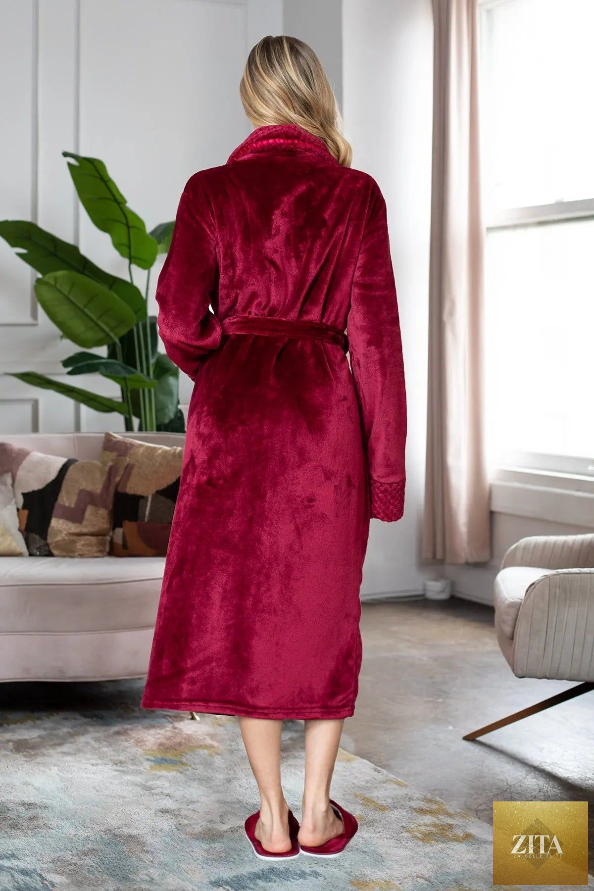 Women’s ultra-soft plush bathrobe from Lotus Linen, showing a cozy, light pink robe with a hood and belt for comfortable lounging.