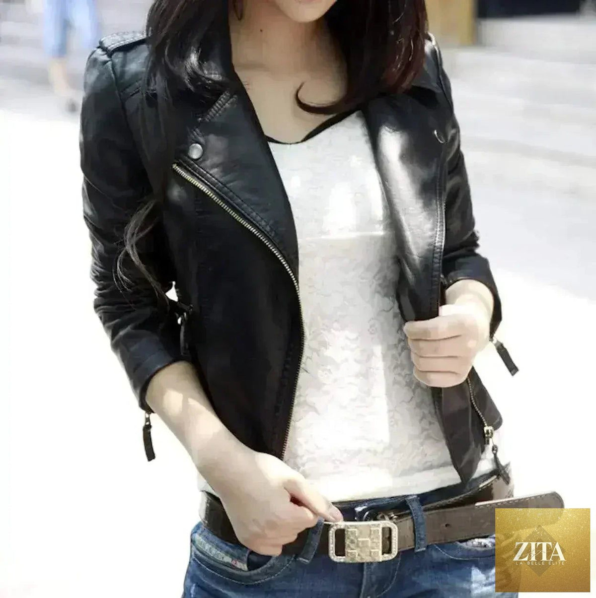 Black vegan leather cropped jacket by Femstylo, slim fit style, shown on a hanger against a plain background.