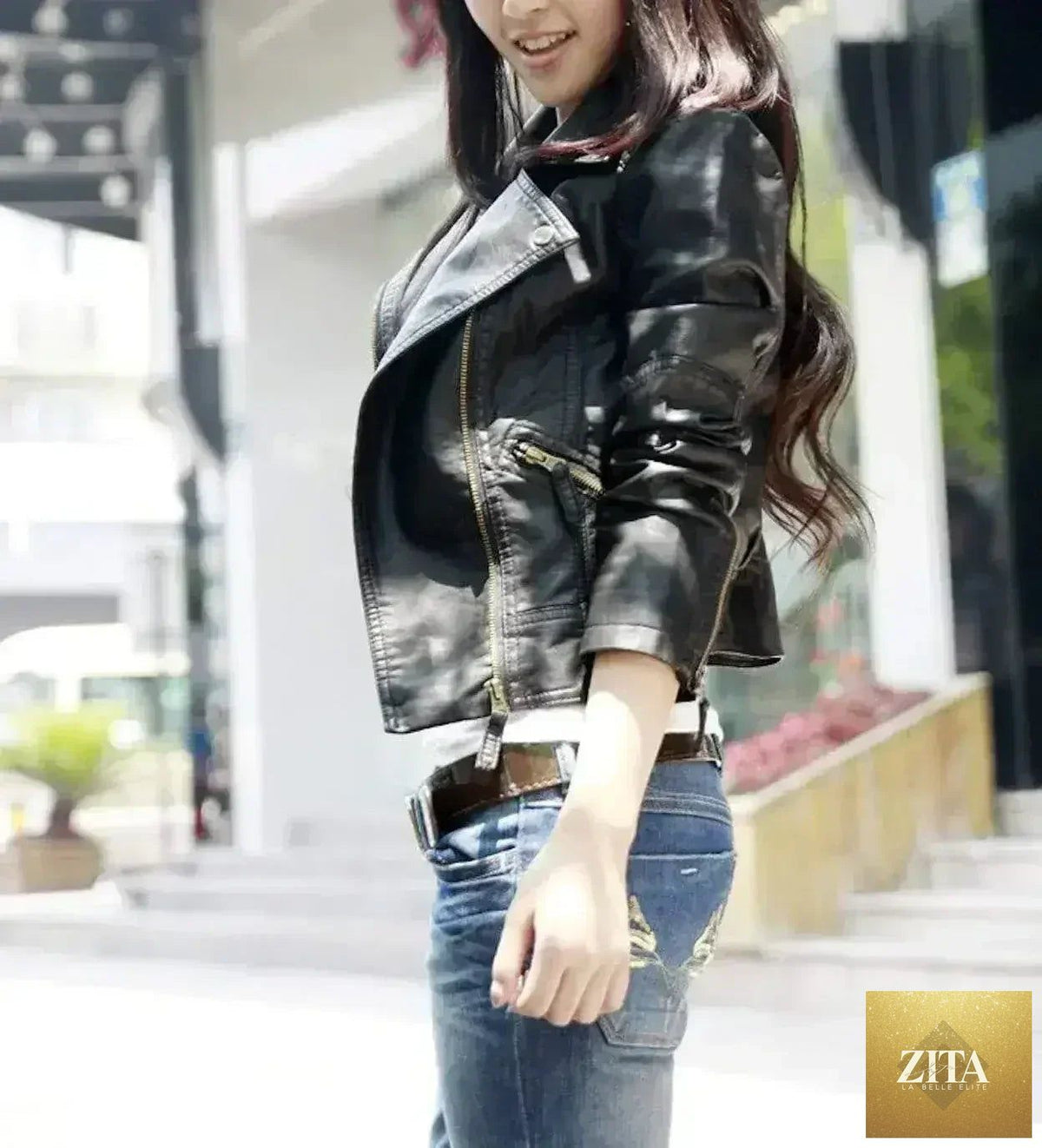 Black vegan leather cropped jacket from Femstylo, slim fit, shown on a model with long sleeves and a high collar.