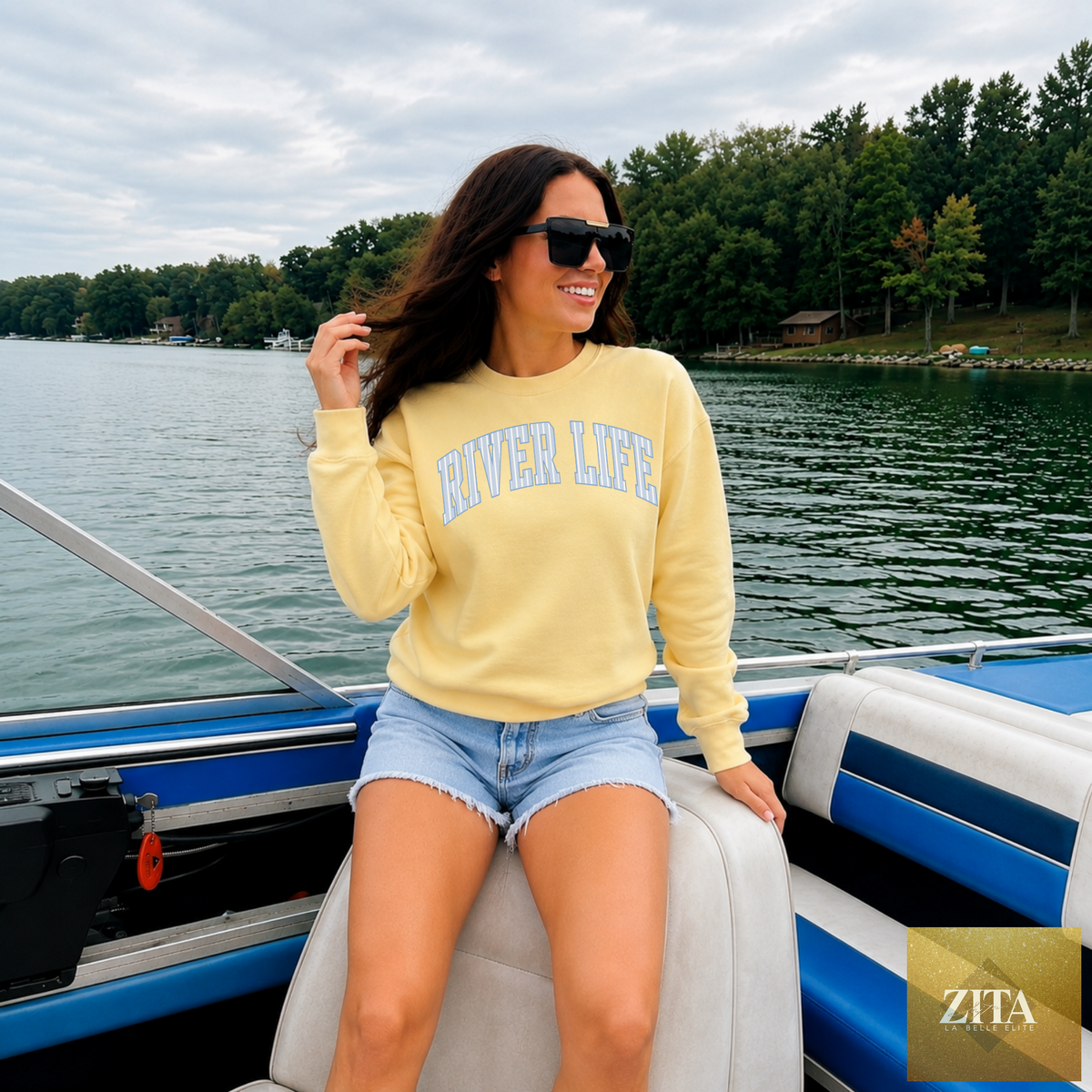 Yellow River Life sweatshirt with graphic design, crewneck style, by Hey Jude Graphic Tees, shown on a flat surface.