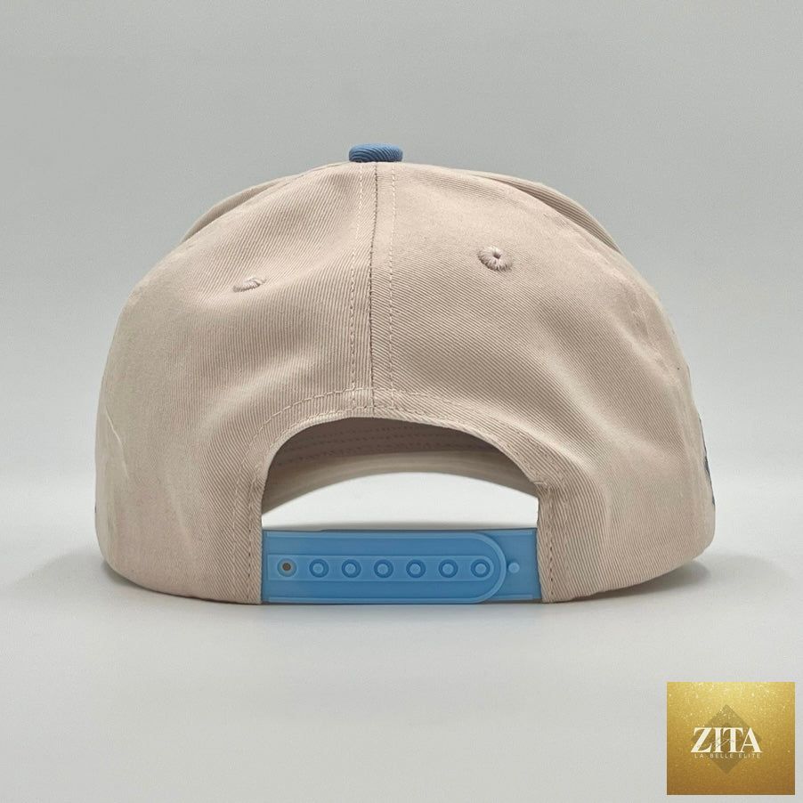 Cream and baby blue structured snapback cap with "YHWH" embroidered, designed by Malta Apparel.