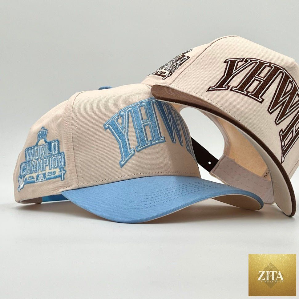 Cream and baby blue structured snapback hat by Malta Apparel with "YHWH" embroidered on front.
