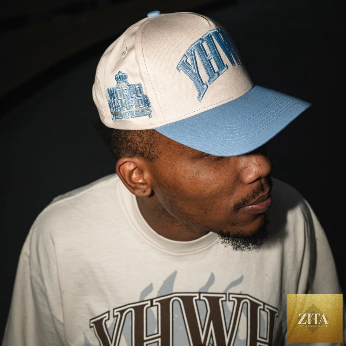 Cream and baby blue structured snapback hat by Malta Apparel with 'YHWH' embroidered design.
