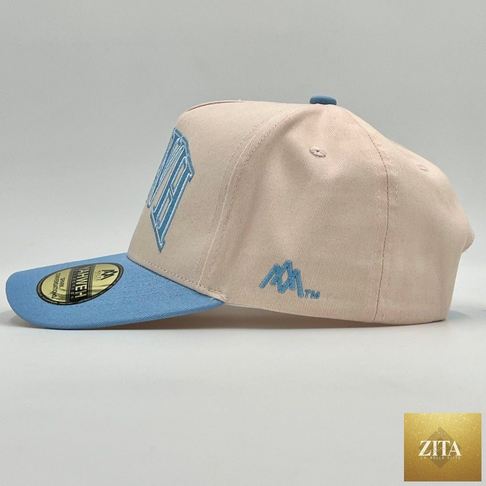Cream and baby blue structured snapback cap by Malta Apparel with “YHWH” embroidered on front, adjustable brim and classic design.