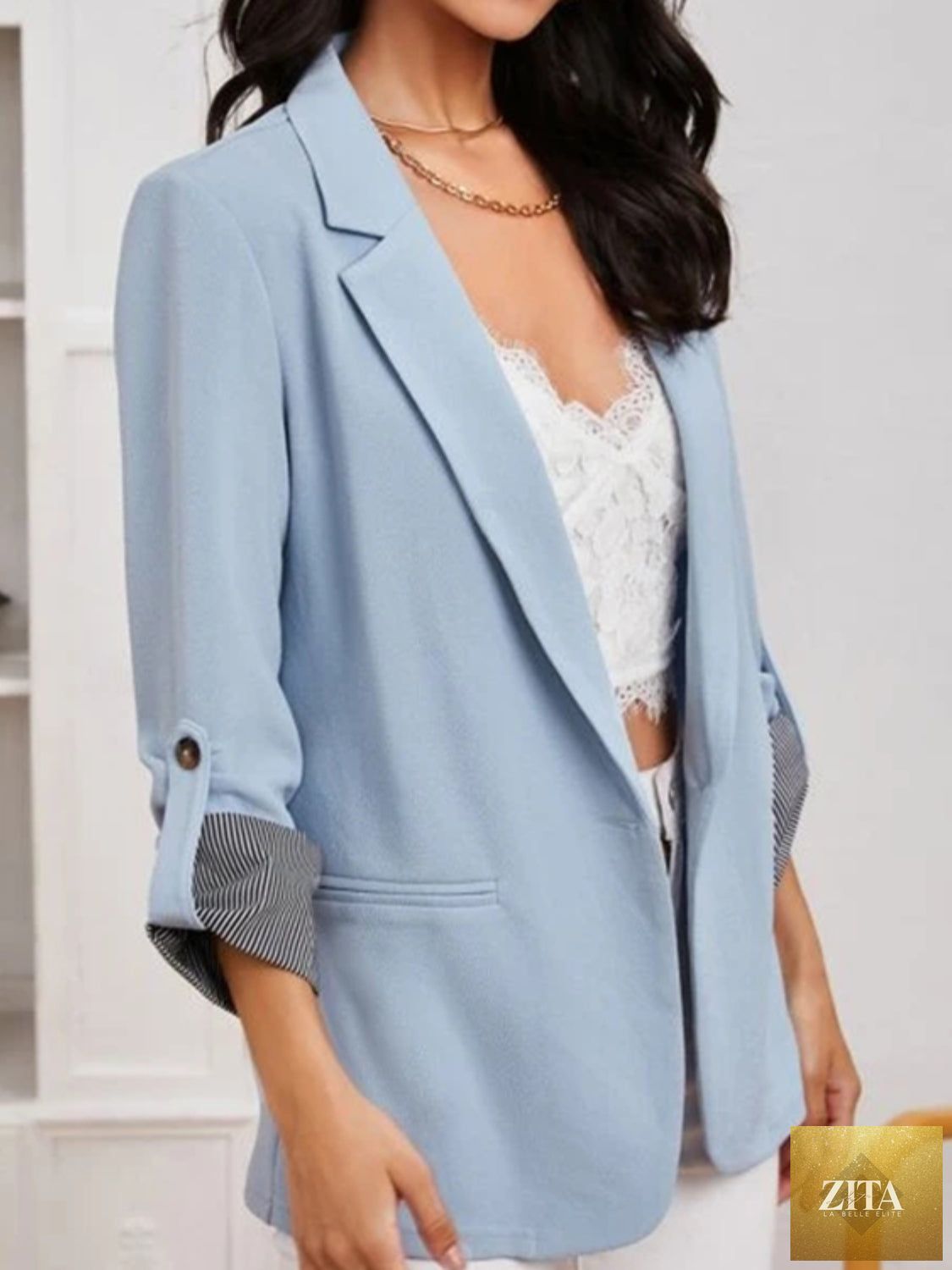 SITRA blazer with lapel collar and roll-tab sleeves, tailored fit, featuring classic design and structured silhouette.