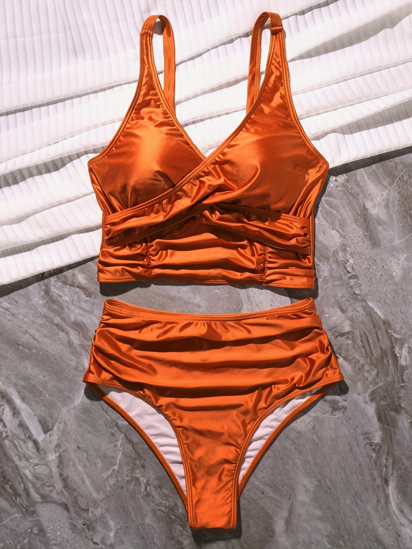Black Stevvex bikini set with twist front, high waist, ruched tummy control, cross strap, and V-neck for beach or poolside wear.