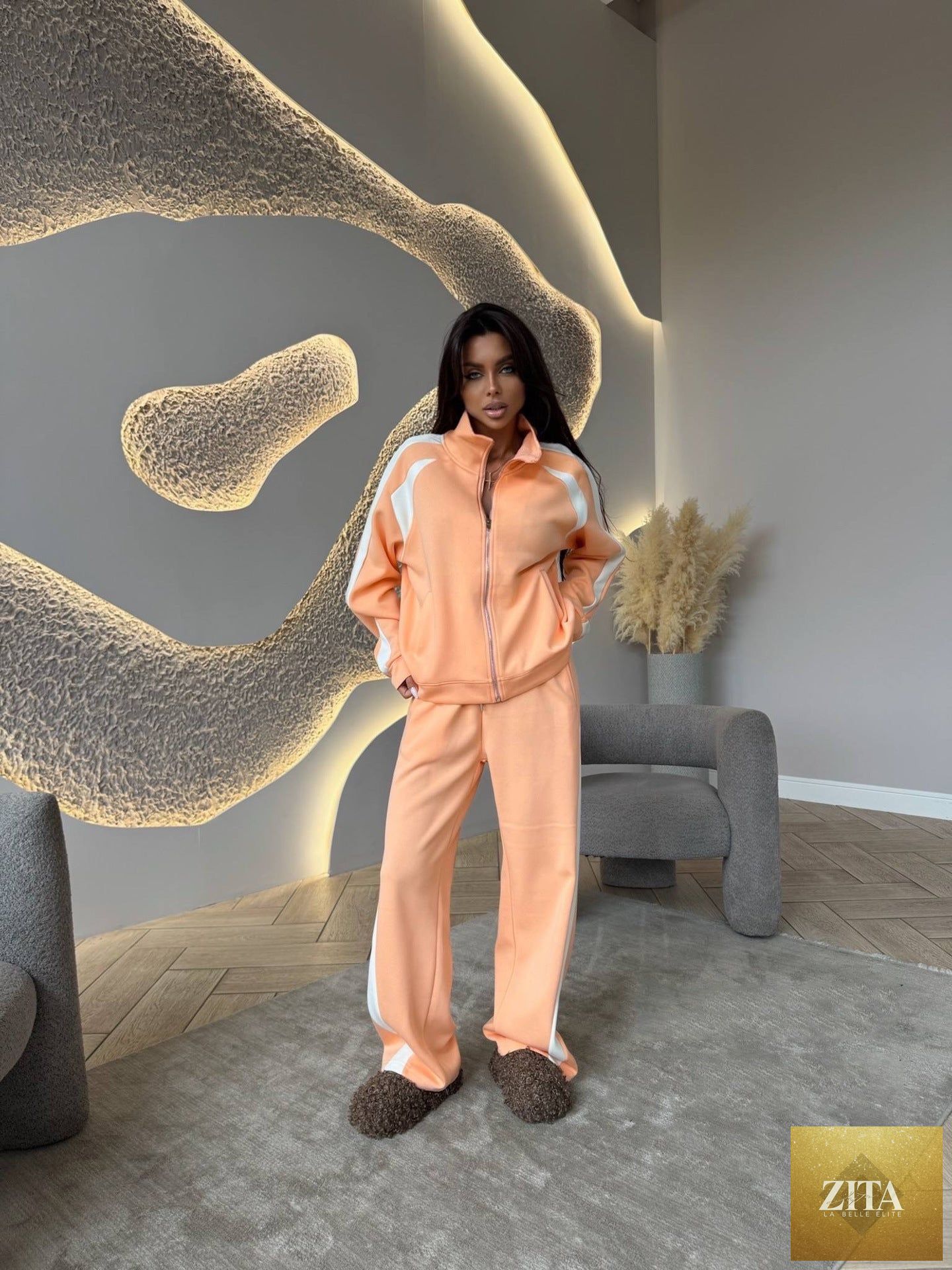 Women’s long-sleeve zip-up jacket and matching sweatpants two-piece set by FitiqueFit, shown in a casual, comfortable fit.