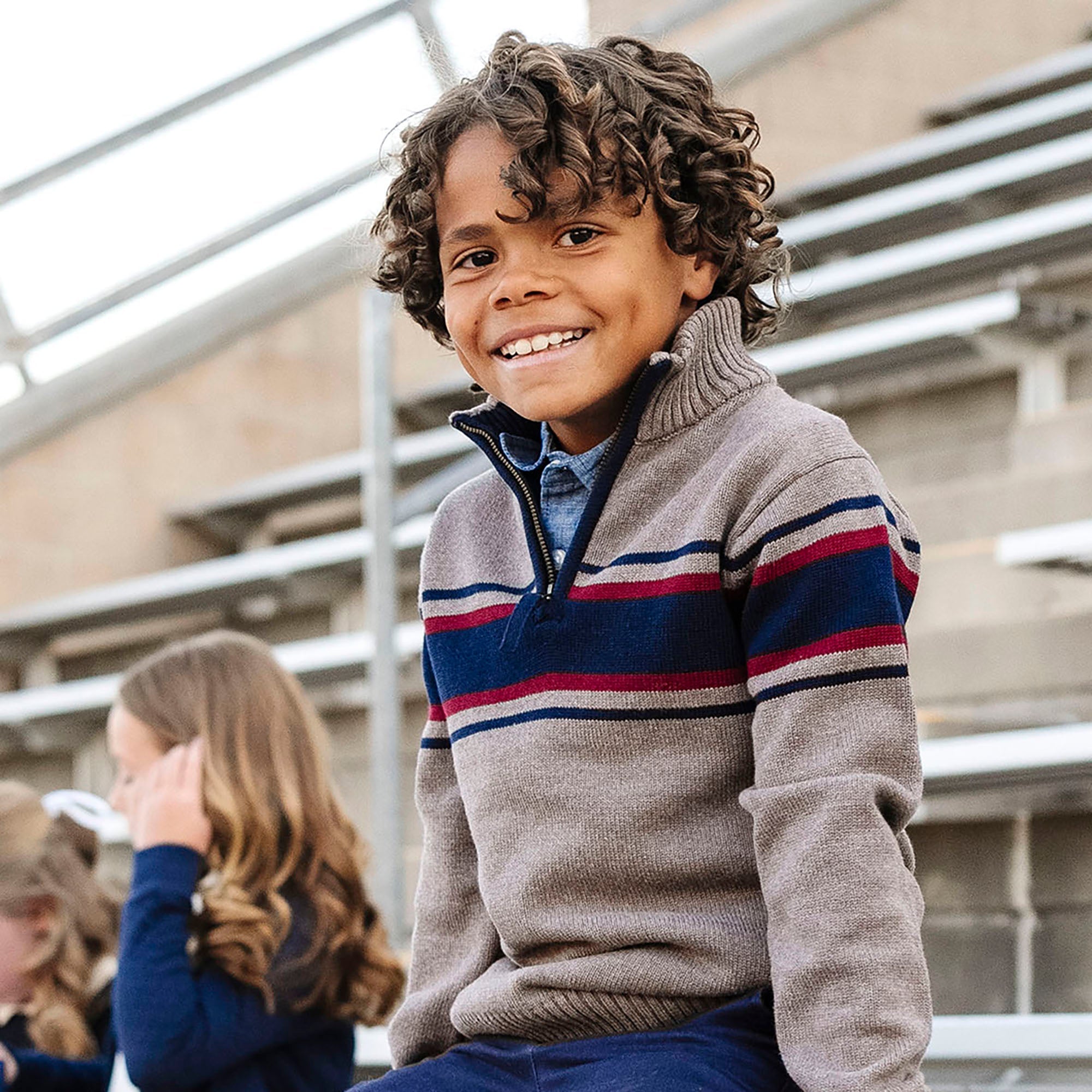Hope & Henry organic half zip sweater, showing a cozy, light-colored knit sweater worn casually in a lifestyle setting.