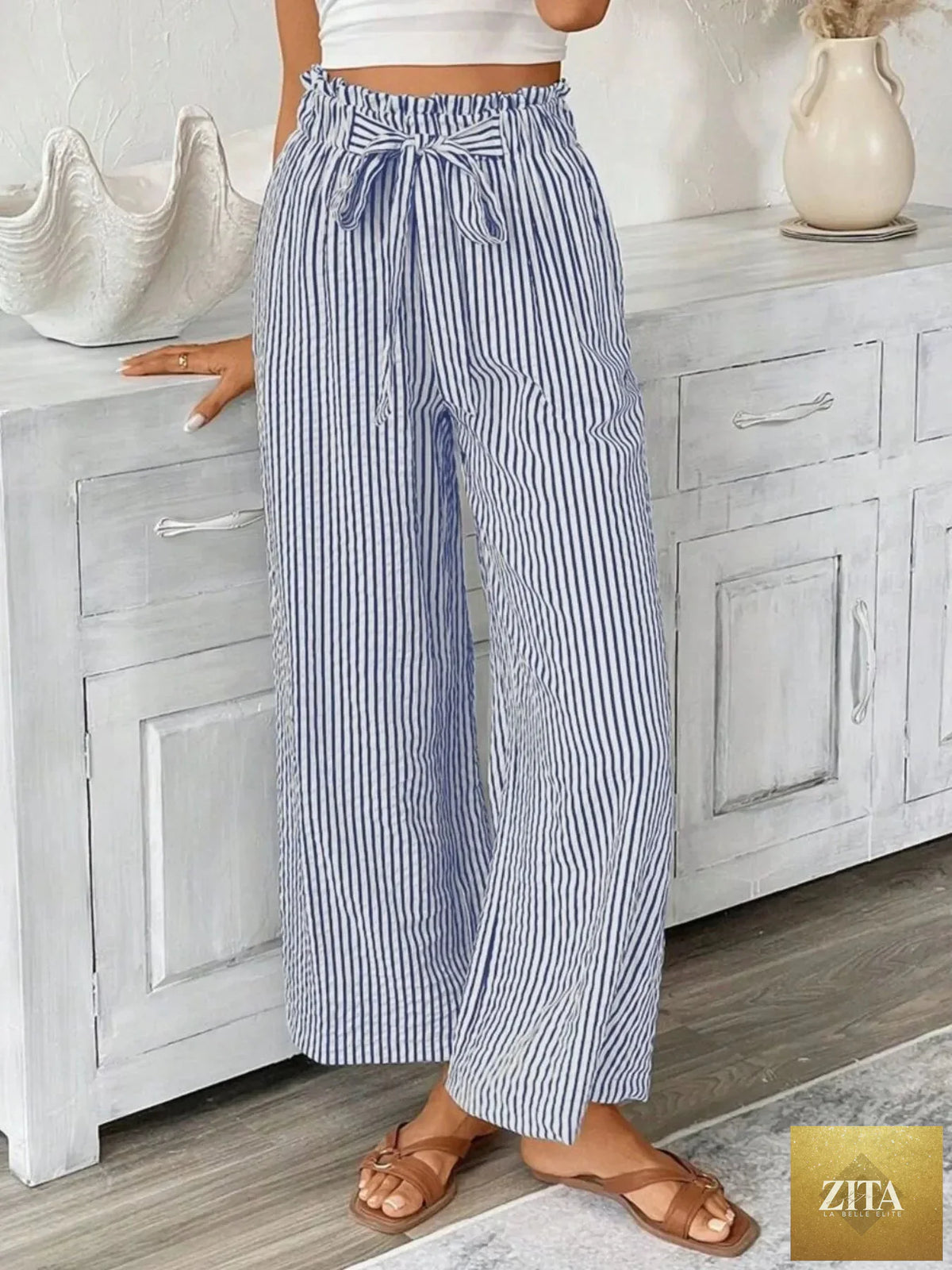 Plus size SITRA striped wide leg paper bag pants with a high waist and relaxed fit, featuring bold vertical stripes.