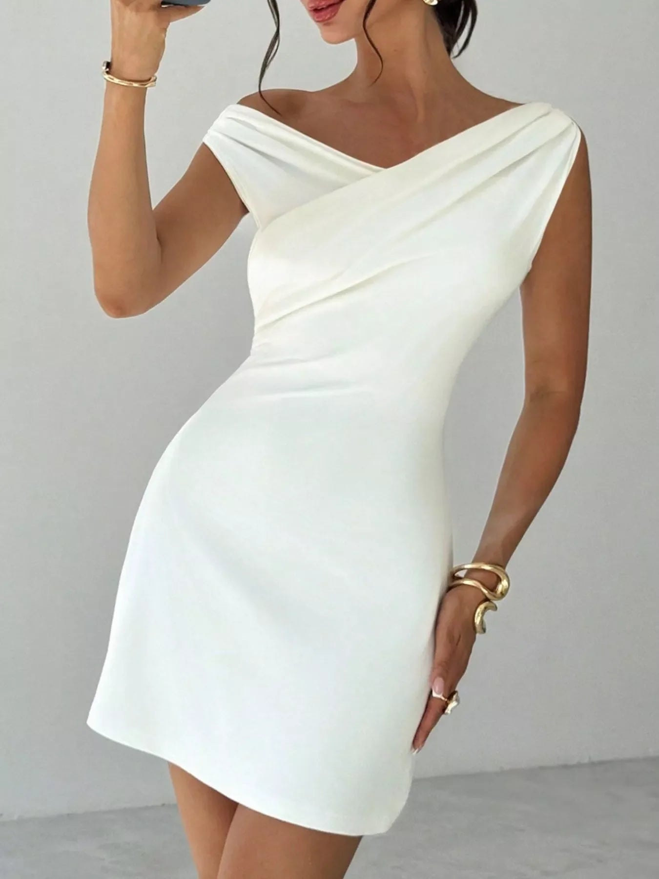 Elegant off-shoulder draped mini dress from Shopiebay, showcasing a stylish design with flowing fabric and a fitted silhouette.