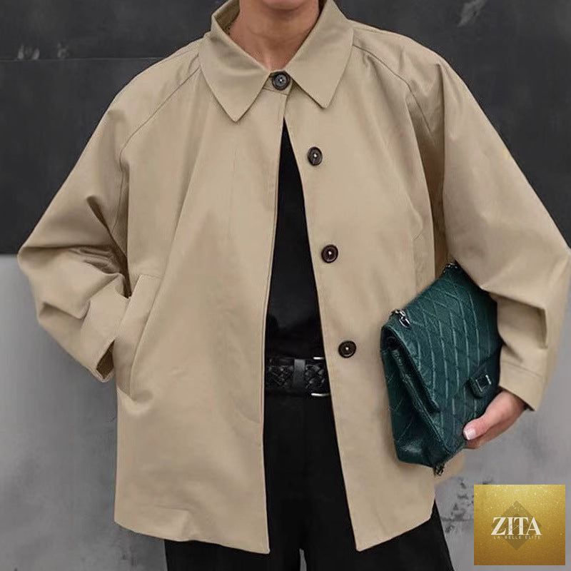 Women's French-style loose mid-length trench coat by FitiqueFit, shown in a beige color with classic lapels and belted waist.