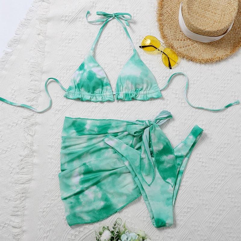 Stevvex 3-piece women’s bikini set with high-cut design, halter top, wrap skirt, lace-up strings, and backless style.