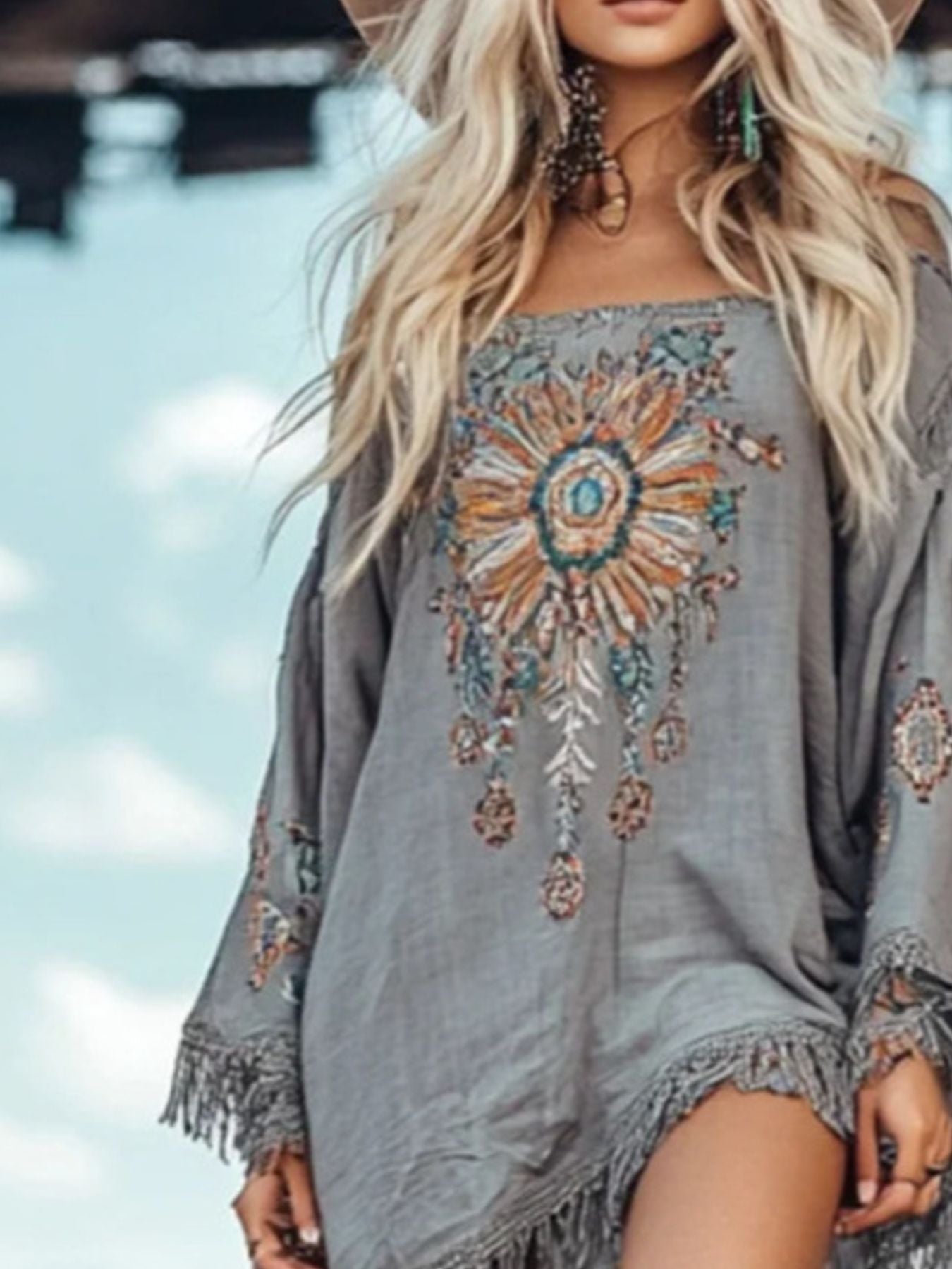 Shopiebay fringe hem long sleeve mini dress featuring a stylish design and flowing fringe details on the hem.