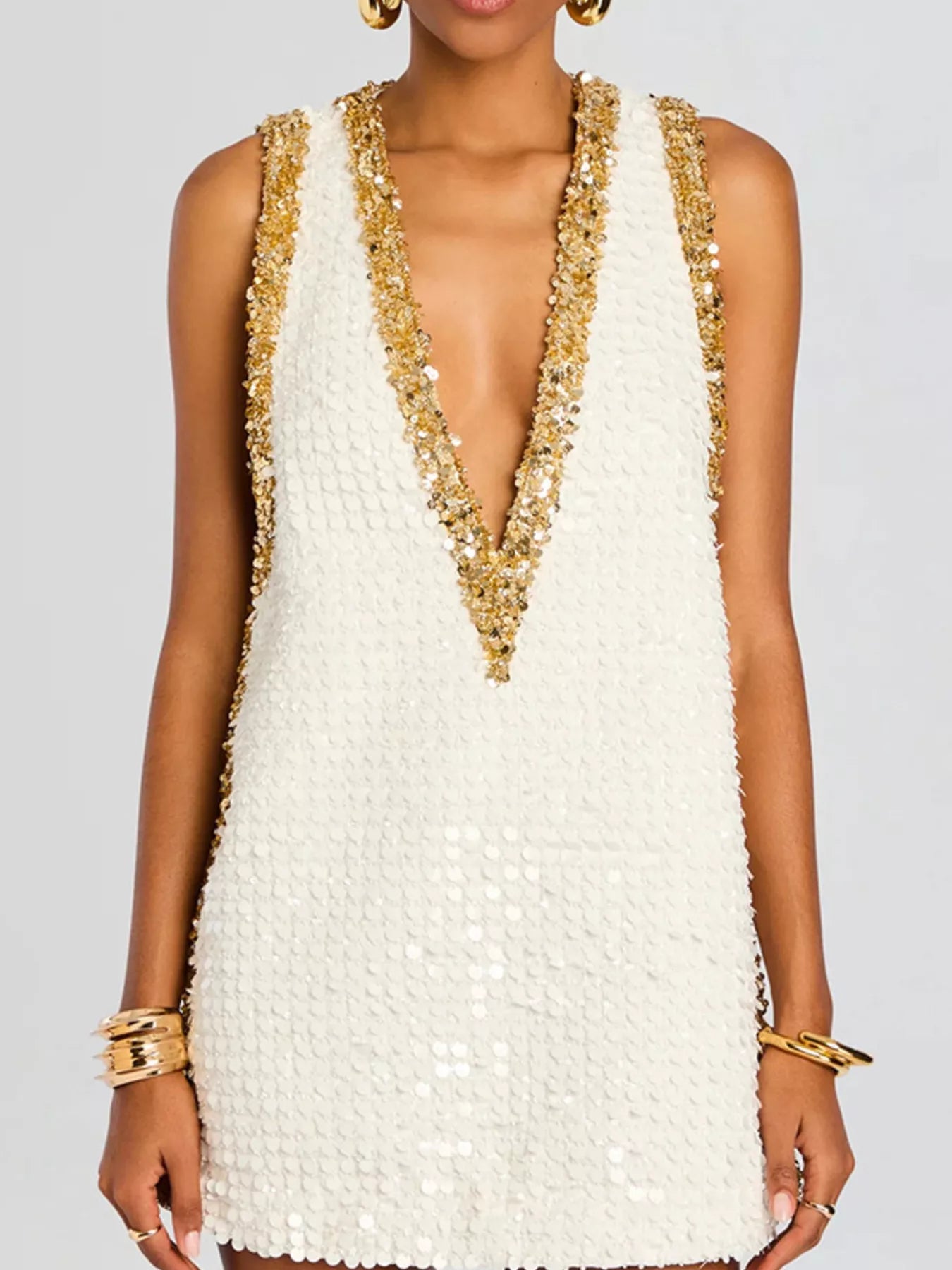 Sequin embellished sleeveless mini dress by Shopiebay, featuring glittering sequins and a fitted sleeveless design for stylish occasions.
