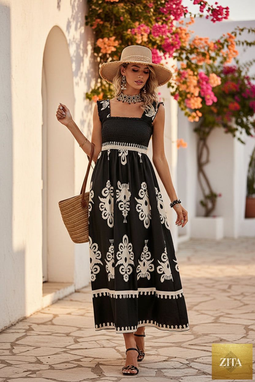 Women's wide-strap printed maxi dress by MERIDGE with smocked bodice and tassel waist, shown on a model in a casual outdoor setting.