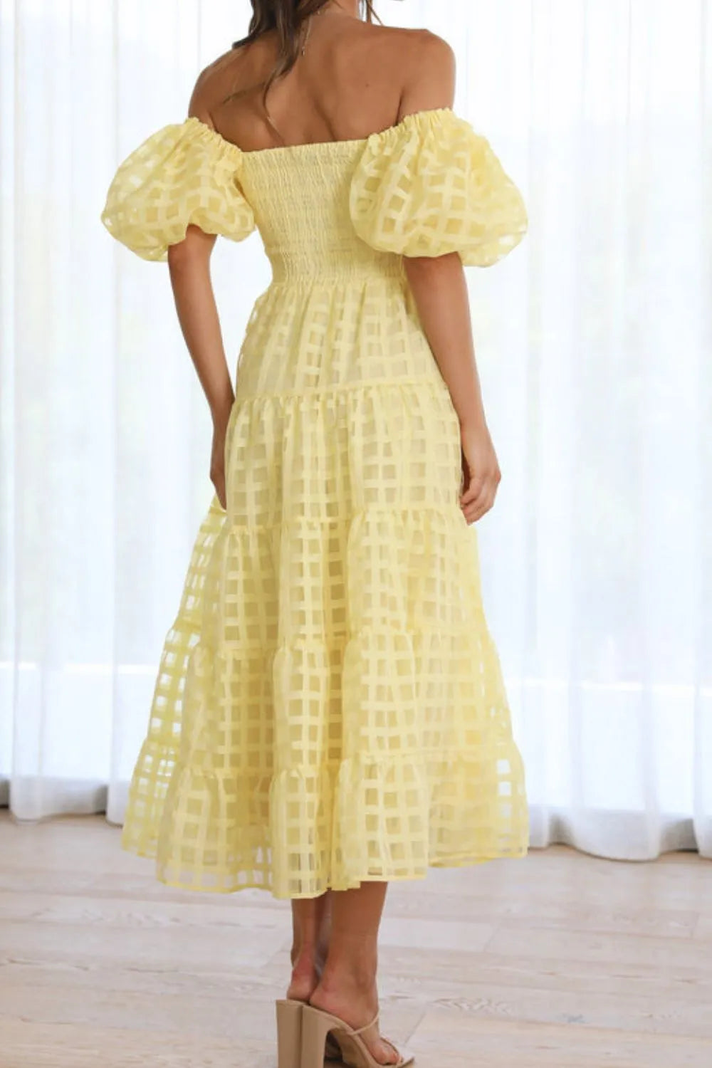 Off shoulder short puff sleeve midi dress from Shopiebay featuring a stylish and elegant design with a fitted waist and flowy skirt.