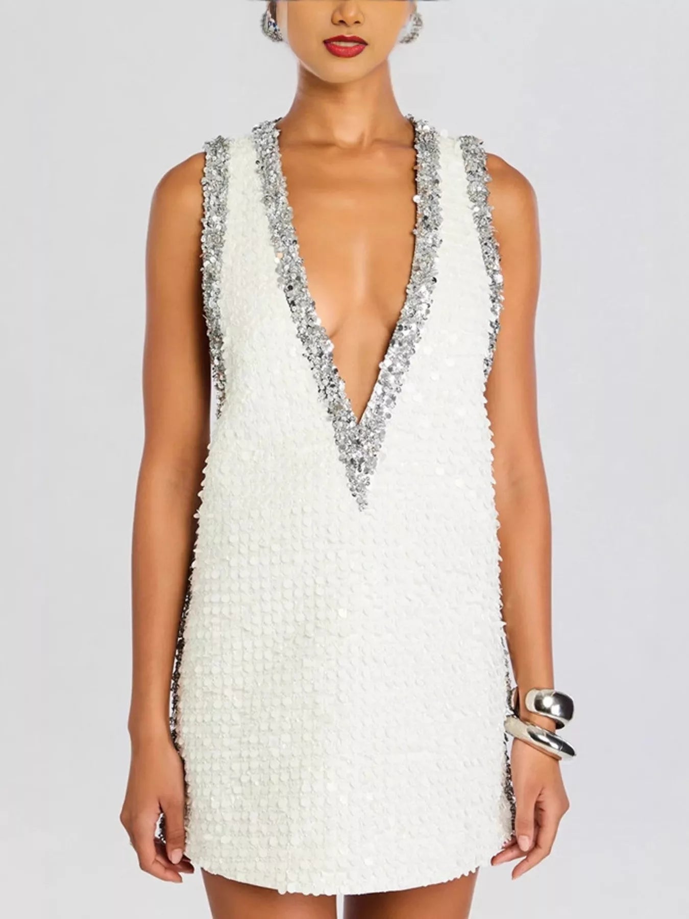 Sequin embellished sleeveless mini dress by Shopiebay, featuring shimmering sequins and a fitted sleeveless design.