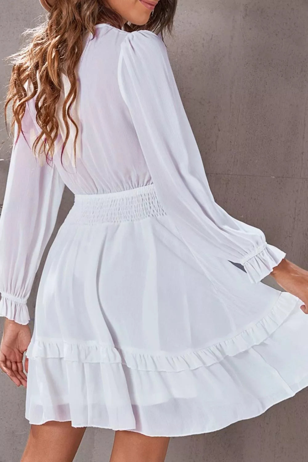 Elegant tie-front ruffle mini dress with smocked waist by Shopiebay, featuring a stylish design and feminine details.