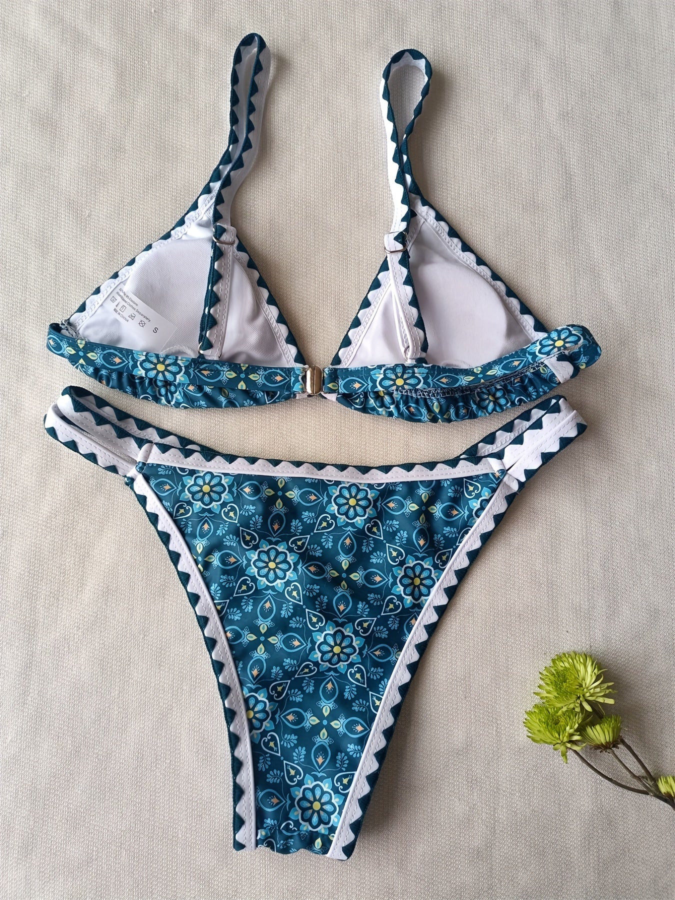 Stevvex Blossom Charm high-cut bikini set featuring floral print, embroidered cut-out triangle top, contrast trim, and back buckle.