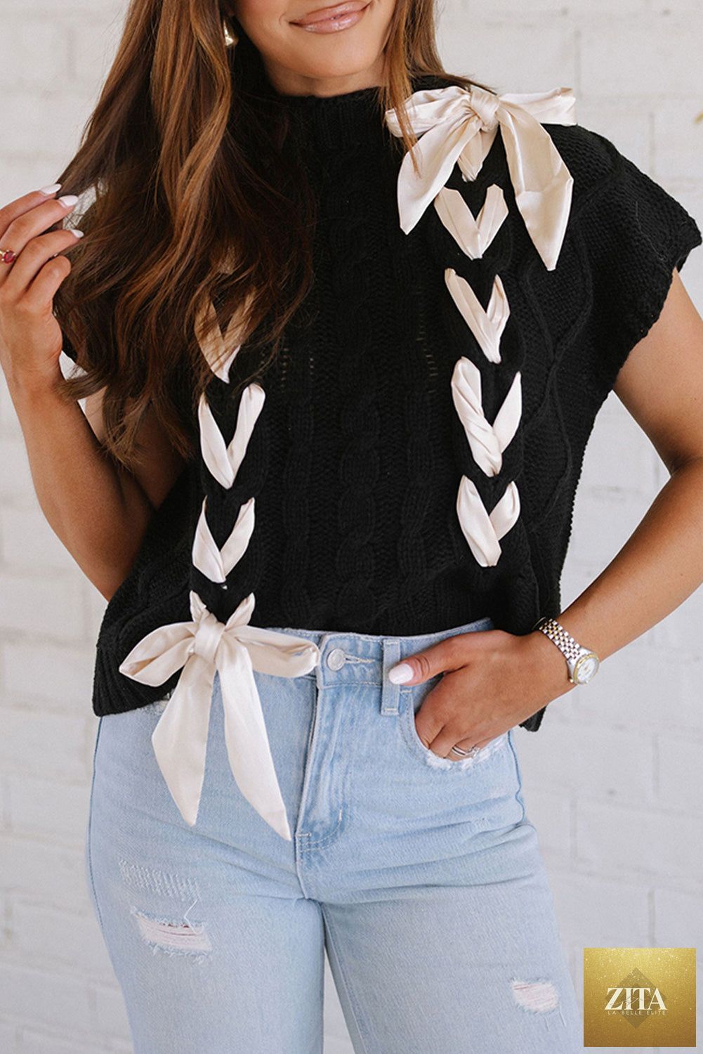 Black cable knit short sleeve sweater by Unique Oils with colorblock satin bowknot detail, stylish and cozy knitwear.