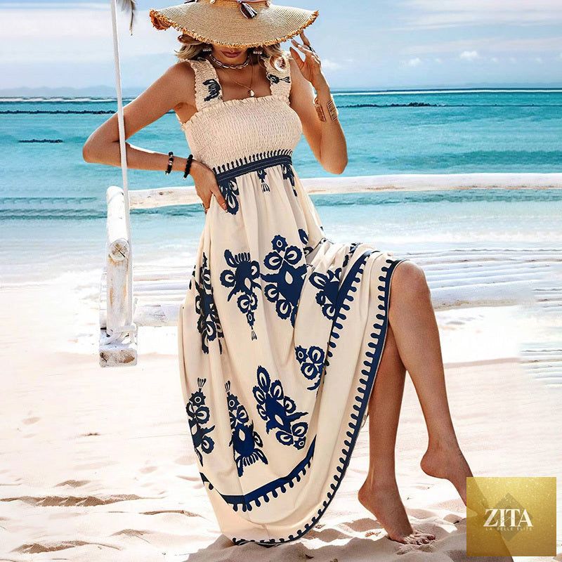 Women's printed maxi dress by MERIDGE with wide straps, smocked bodice, and tassel waist, featuring a flowing, stylish design.