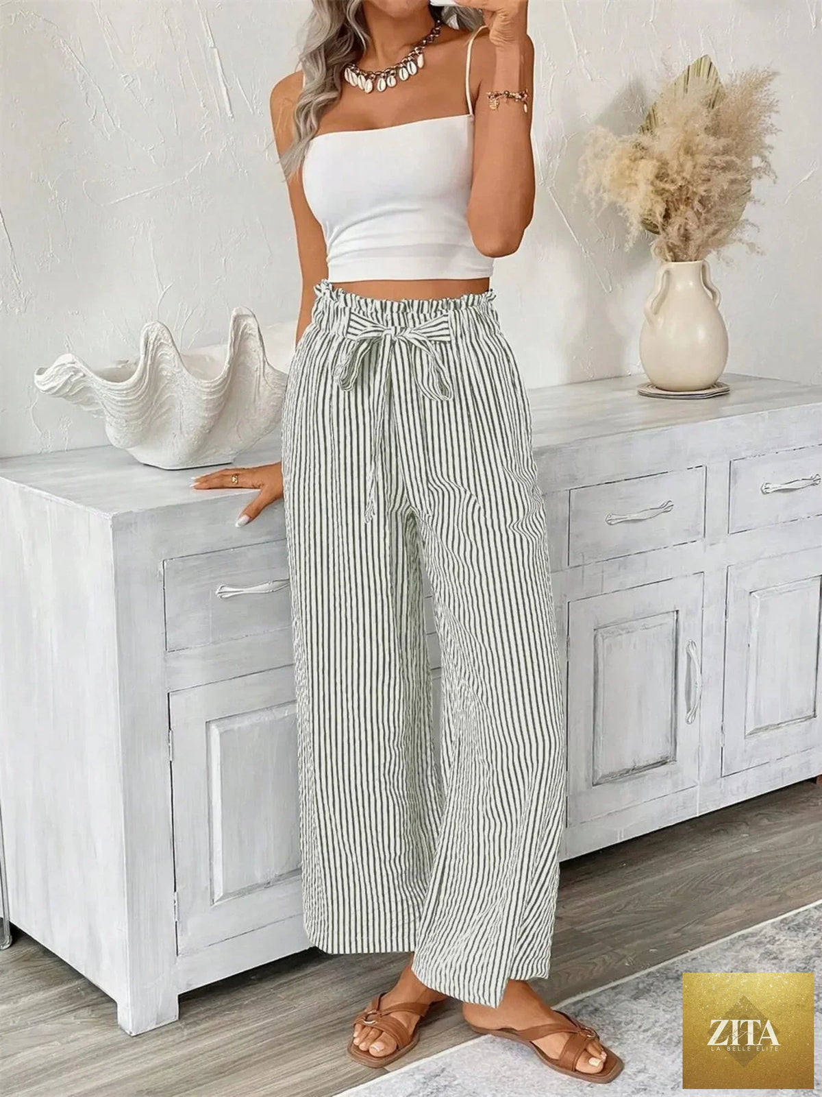 Plus size striped wide-leg paper bag pants by SITRA, featuring a full-length design and high-rise waist, styled for a relaxed fit.