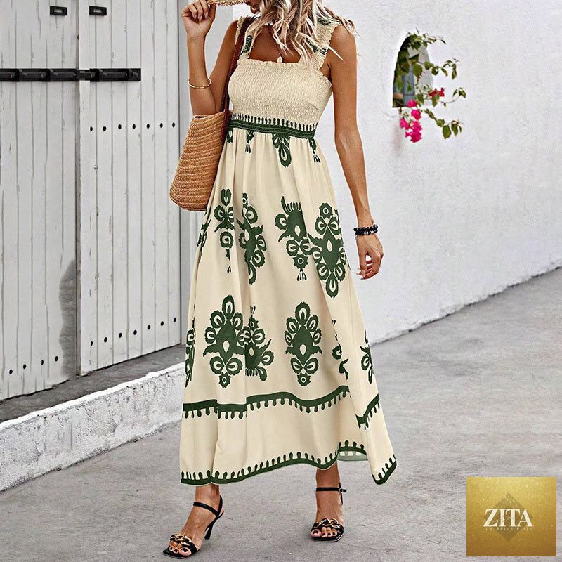 Women's wide-strap printed maxi dress by MERIDGE with smocked bodice and tassel waist, featuring a flowy, vibrant design.