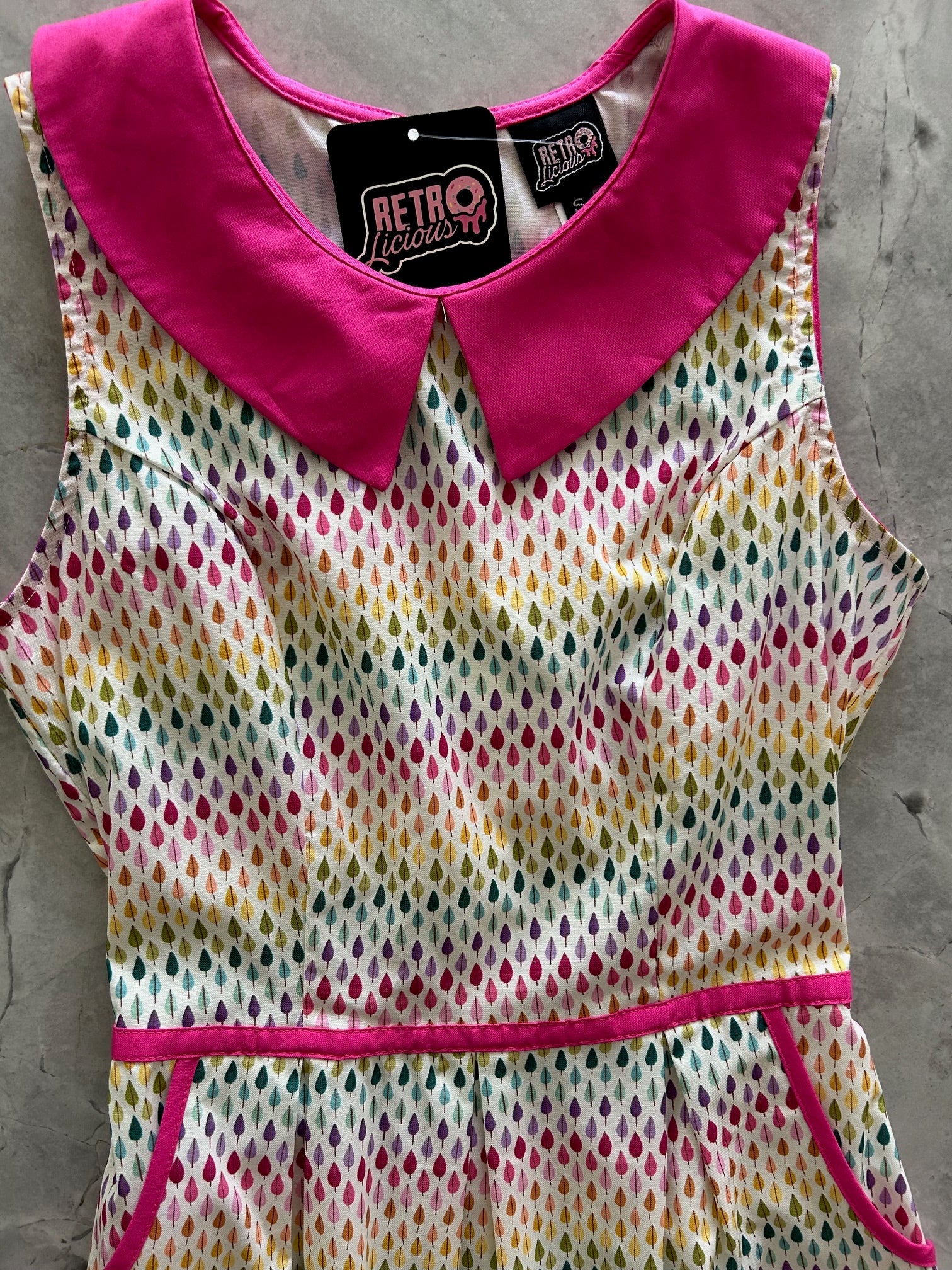 Rainbow Drop Collared Dress by Retrolicious featuring a colorful, playful design with a tailored collar and vibrant fabric.
