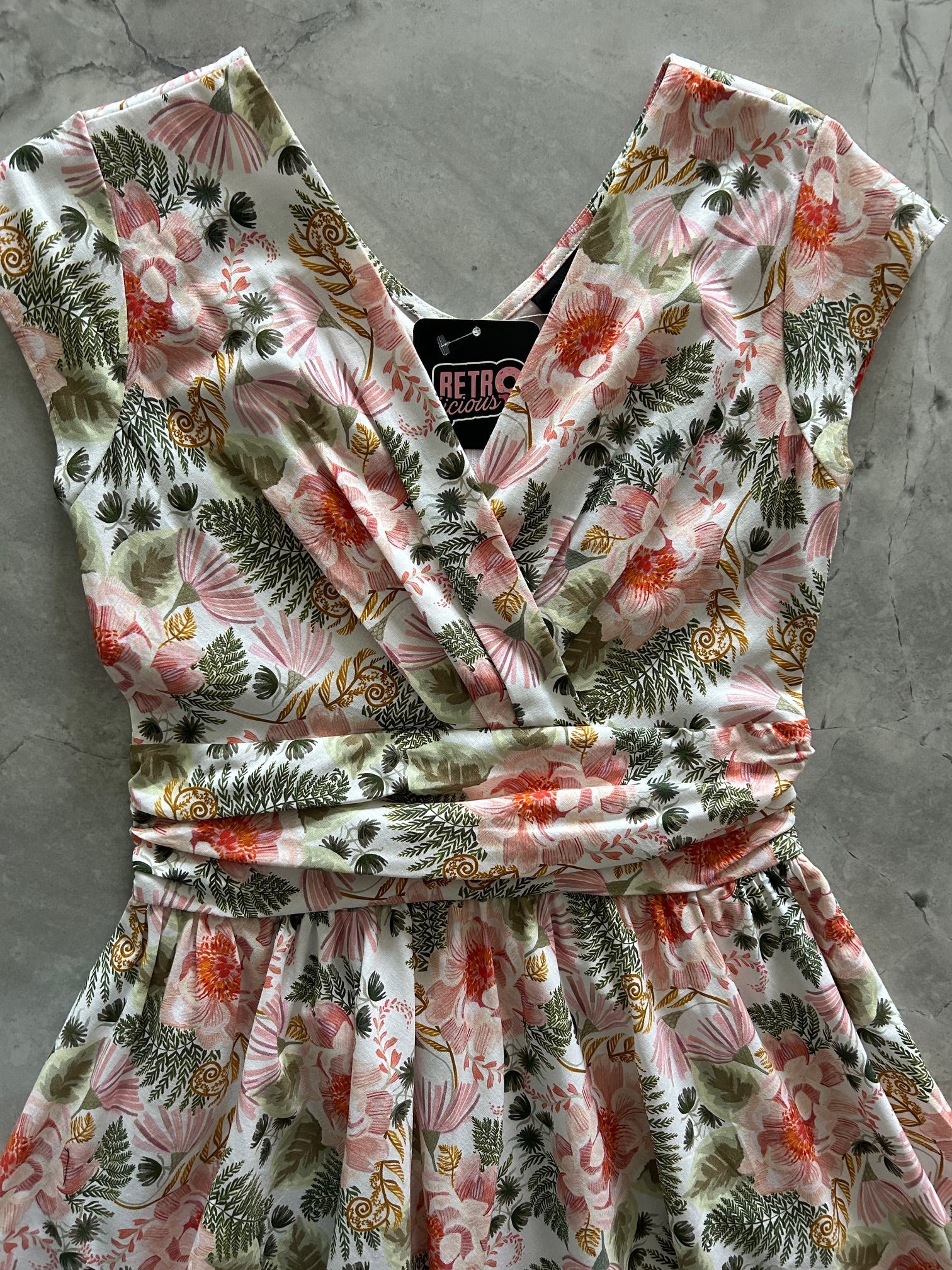 Pink floral Greta dress from Retrolicious featuring a vintage-inspired design and feminine details.