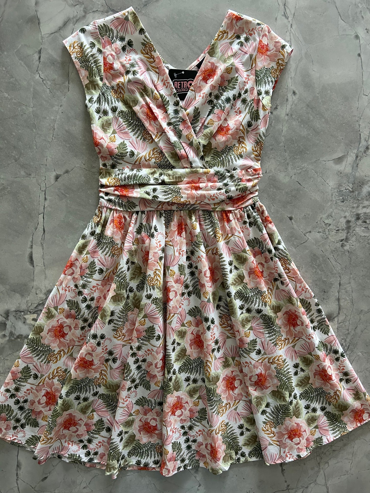 Pink floral Greta dress by Retrolicious, featuring a vintage-inspired floral pattern and classic dress silhouette.