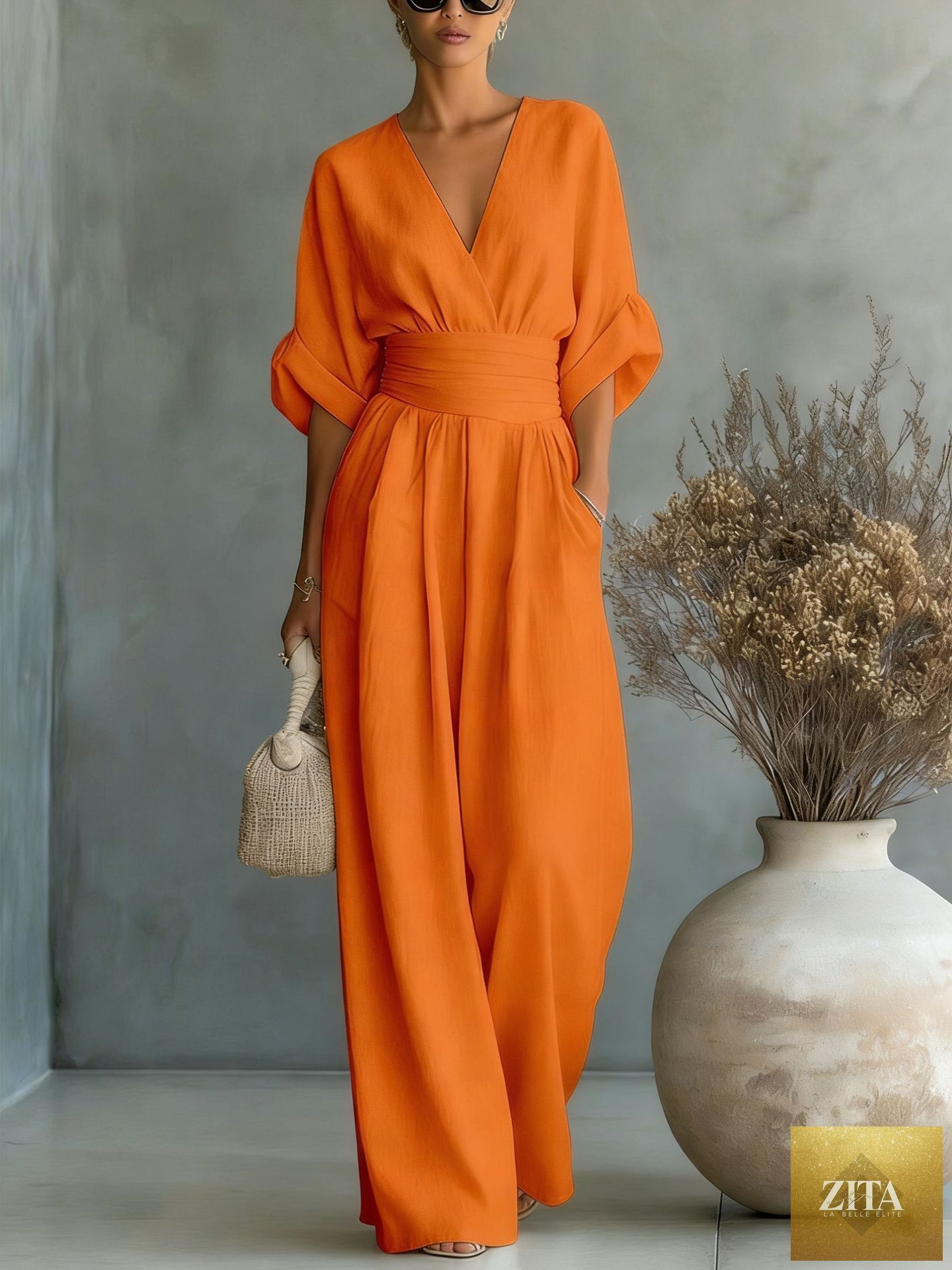 Women's V-neck wide-leg jumpsuit by MERIDGE featuring high waist and pleated design, shown in a stylish, elegant fit.