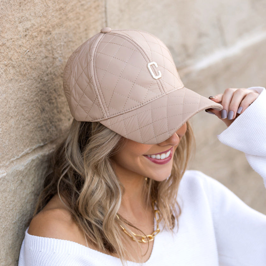 Aili's Corner quilted puffer baseball cap with a rounded crown and adjustable strap, featuring a quilted puffer design for a stylish look.