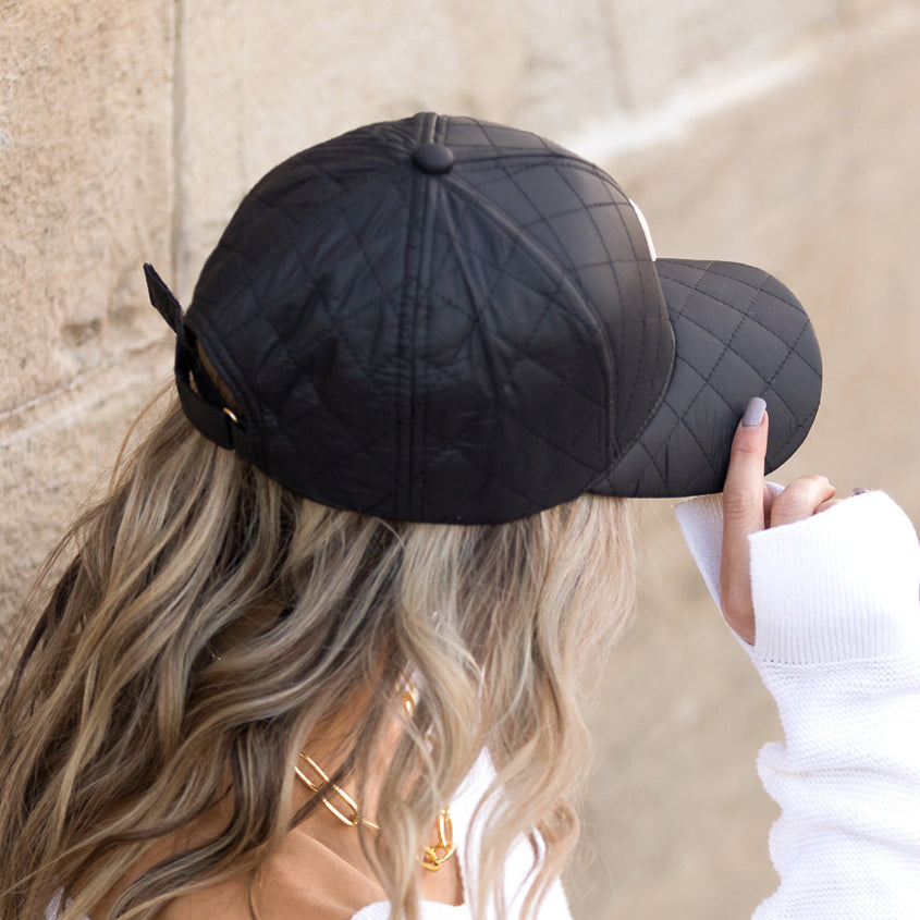 Aili's Corner quilted puffer baseball cap with a rounded brim and quilted fabric, stylish and warm for casual wear.