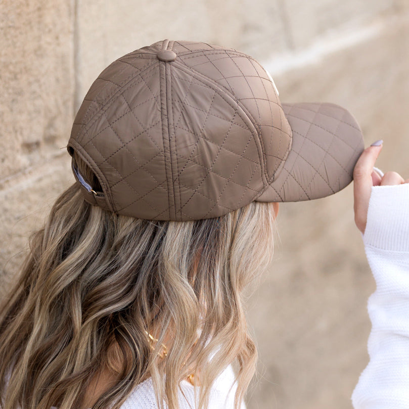 Aili's Corner quilted puffer baseball cap with a rounded brim and stitched diamond pattern, stylish and warm for casual wear.