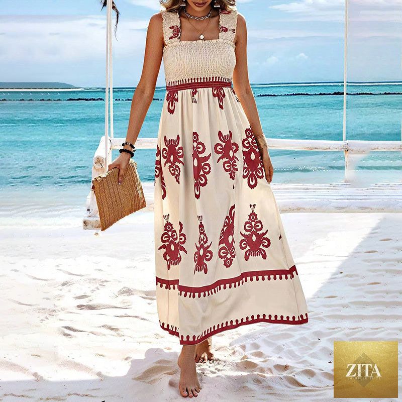 Women's wide-strap printed maxi dress by MERIDGE featuring a smocked bodice and tassel waist, shown on a model outdoors.