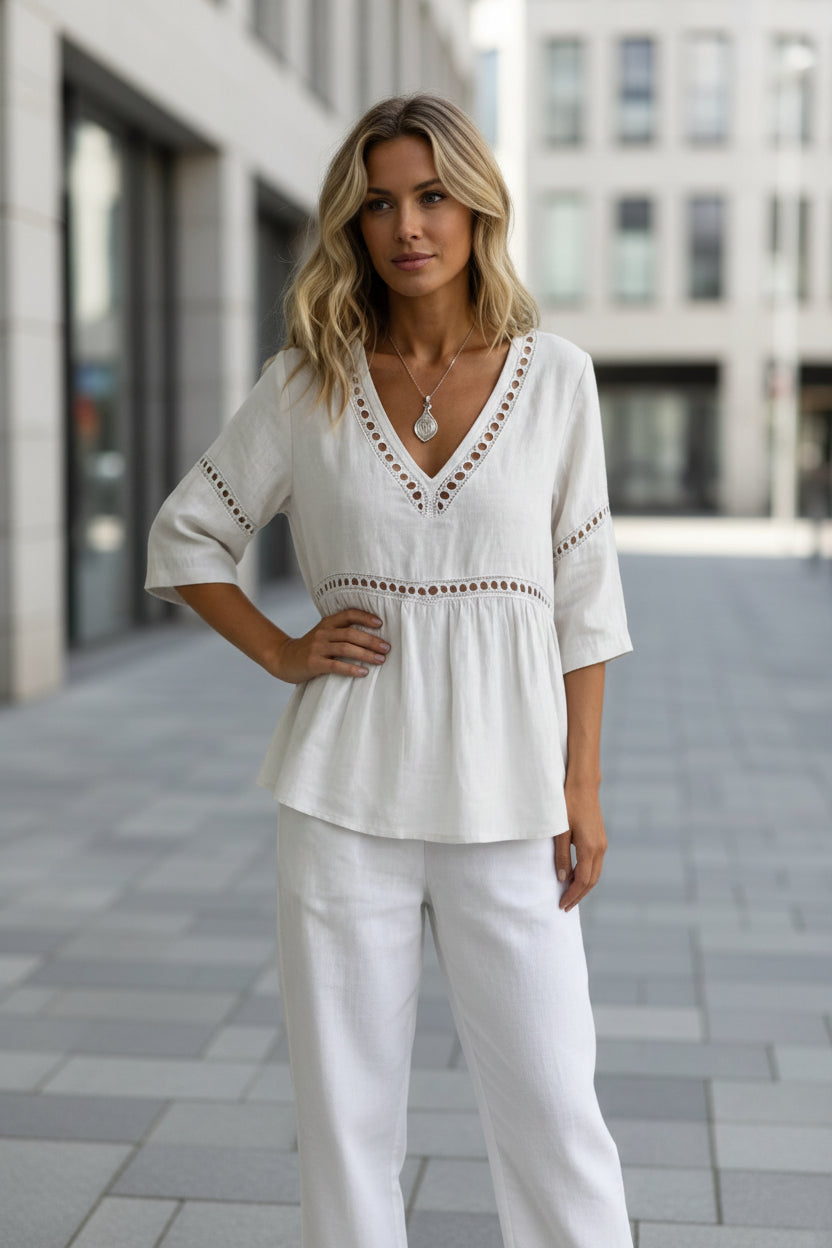 Women's V-neck cotton-linen top with fringe and hollow-out details, casualwear by FitiqueFit, shown on a hanger.