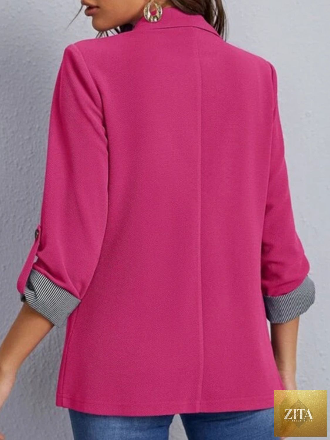 SITRA blazer with lapel collar, roll-tab sleeves, tailored fit, in a classic style, shown on a hanger.