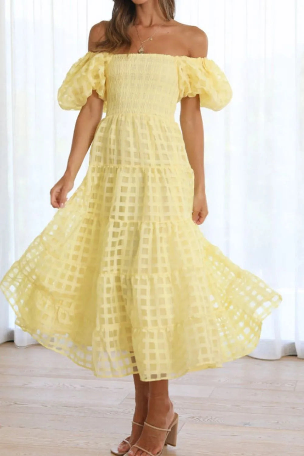 Off shoulder short puff sleeve midi dress by Shopiebay, featuring a stylish neckline and flowy fabric in a graceful design.