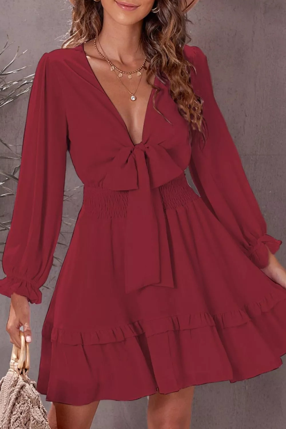 Elegant Shopiebay tie-front ruffle mini dress with smocked waist, featuring flowing fabric and feminine detailing.