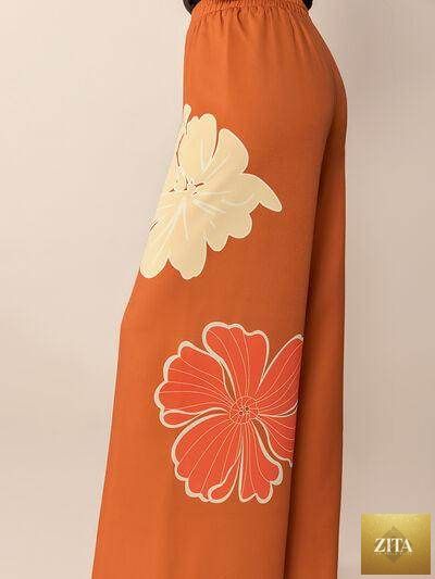 Printed elastic waist wide leg pants by Selvanelle featuring comfortable fit and stylish design, shown on a model.