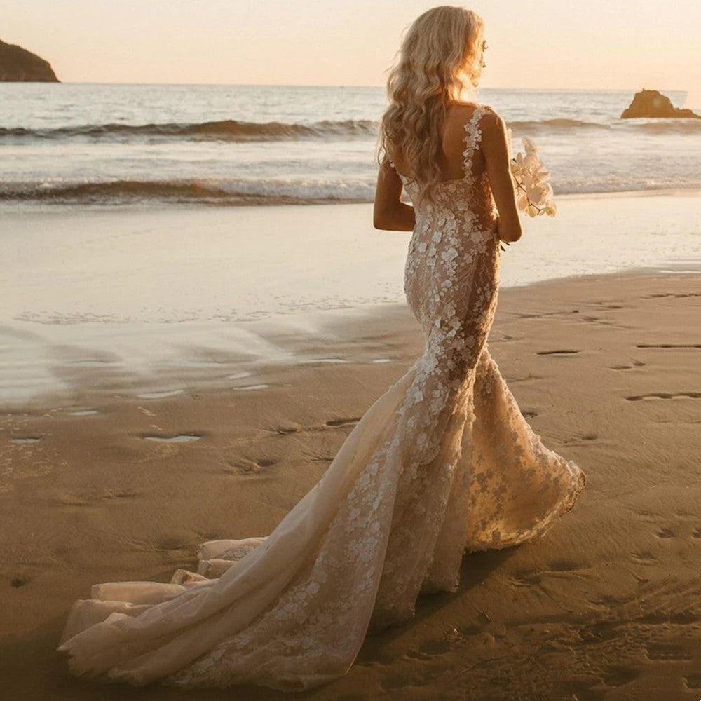 Elegant mermaid wedding dress by FLIPSTYLEZLLC with intricate 3D lace appliques and a fitted silhouette.