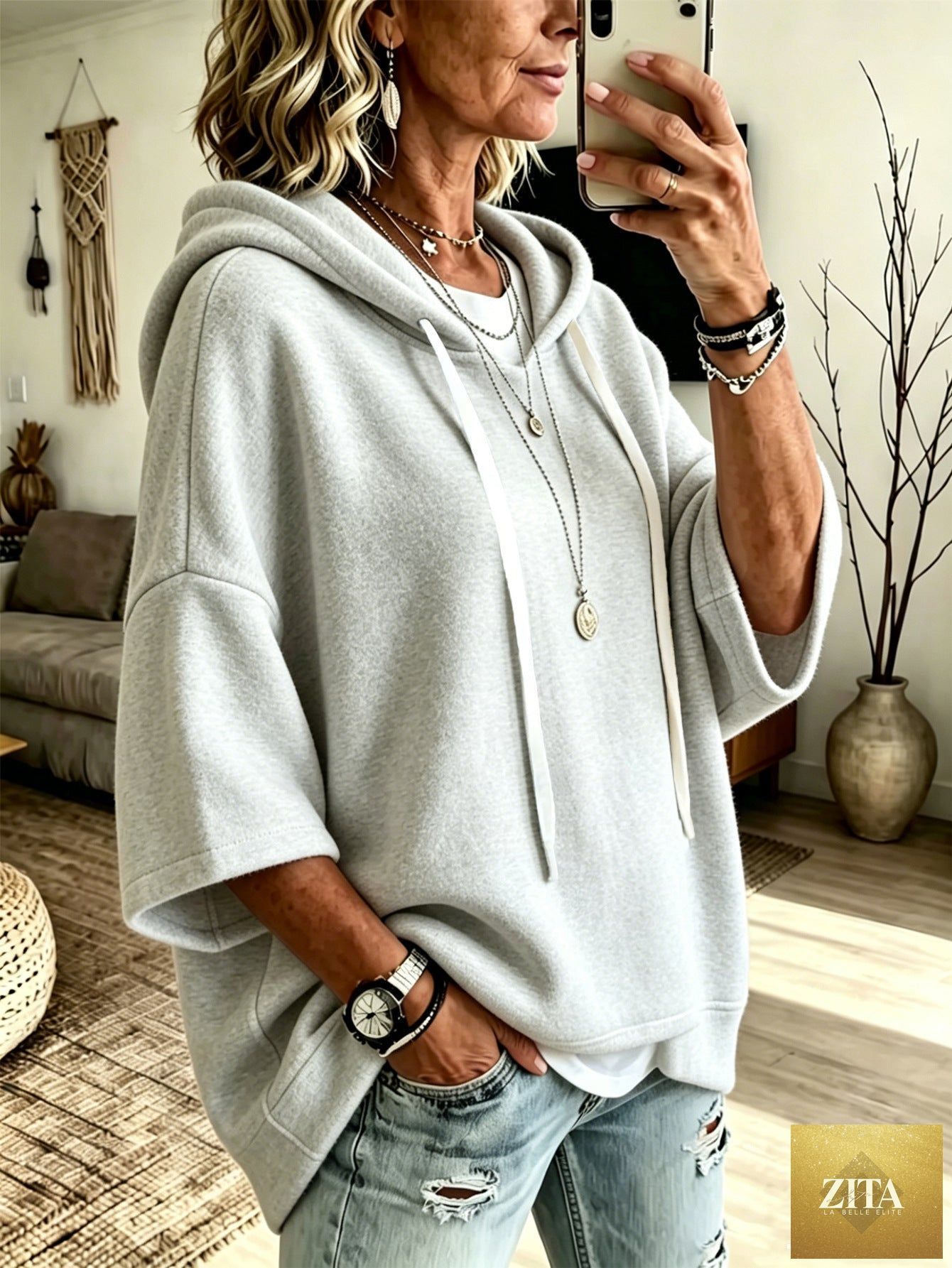 Women's oversized batwing sleeve hoodie by FitiqueFit, loose fleece pullover with relaxed fit and cozy design, shown on a model.